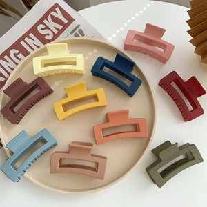 Large matte rectangular hair claw clips in elegant Morandi colors on a tray