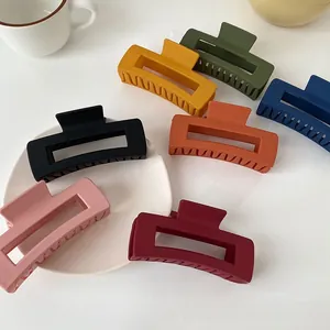 Detailed view of colorful large rectangular matte hair claws in various vibrant shades