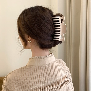 Elegant matte beige hair claw clip for large volume hair updo shown on model's head