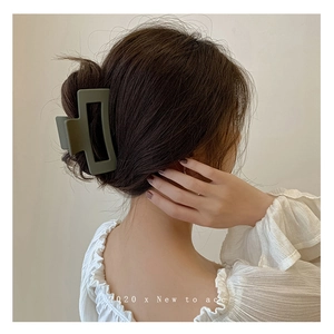 Olive green matte rectangular hair claw clip shown on a model from the back view