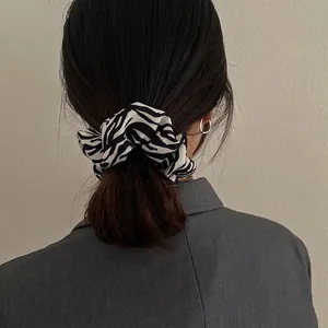 French style zebra print scrunchie hair tie on model with elegant low ponytail styling