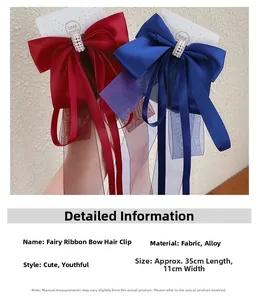 Détail de la pince à cheveux nœud de 35cm avec perle centrale et texture en tissu