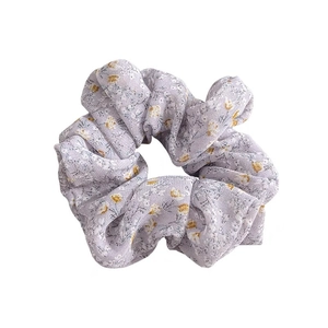 Light purple floral scrunchie with yellow blossoms made of lightweight chiffon fabric