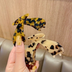 Elegant large acetate claw clips with classic tortoise shell and cream leopard patterns