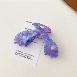 Detail shot of a large acetate claw clip with marble texture in purple and blue hues