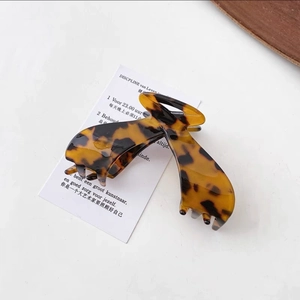 Close-up of a vintage tortoise shell hair claw clip with polished amber finish