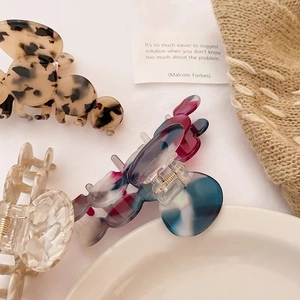 French acetate hair claws in leopard, marble, and beige patterns for elegant styling