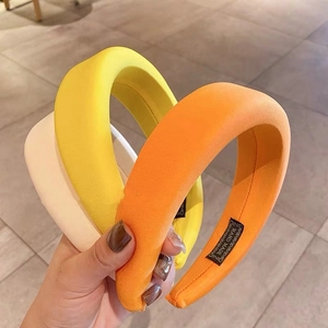 Detailed close-up showing thick sponge headbands in beige, yellow and orange colors