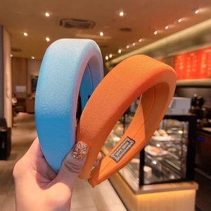 Thick padded sponge headbands in light blue and orange with knitted fabric texture