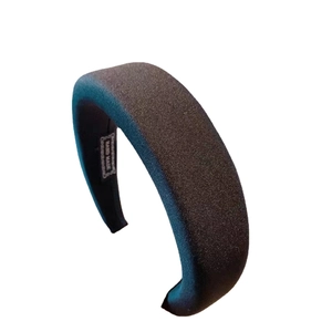 Classic black sponge headband with thick fabric texture and handmade label detail