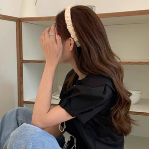 Elegant cream pleated headband for women made of delicate fabric with soft shiny texture