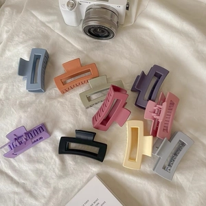 Flat lay of colorful matte rectangular hair claws in Morandi tones for women accessories