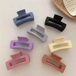 Detail showing various colors of matte square hair claws with a frost texture