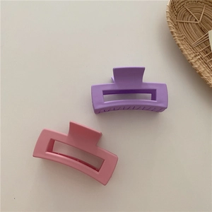 Close-up of matte pastel purple and soft pink rectangular hollow hair claw clips set
