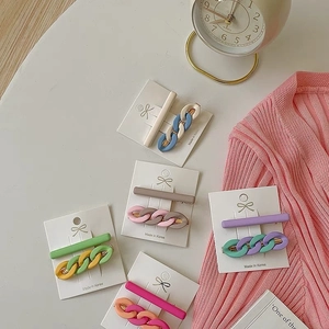 2-piece candy-colored chain hair clips set in matte pastel tones on a display card