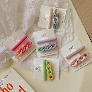 Detail view of 2-piece matte pastel hair clips with chain design on display cards