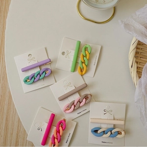 Close-up of pastel macaron resin hair clip set with chain design on a white card