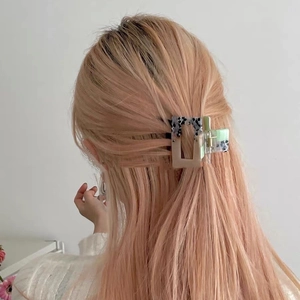Square claw clip with pink, green and leopard print on blonde hair in a half-up style