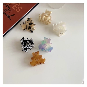 Detailed set of six mini acetate bear hair clips in diverse stylish patterns and colors