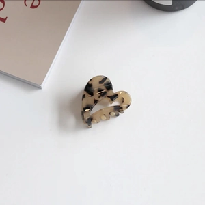 Macro shot of heart-shaped tortoiseshell acetate hair claw with smooth polished teeth