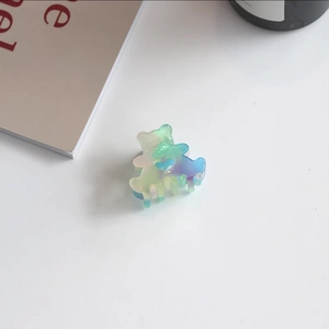 Detail of bear-shaped acetate hair claw clip with colorful jelly gradient finish
