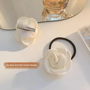 Detail of camellia hair clip with serrated anti-slip design and elastic hair tie