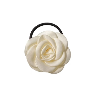 Elegant white camellia hair scrunchie with layered fabric petals and black elastic band
