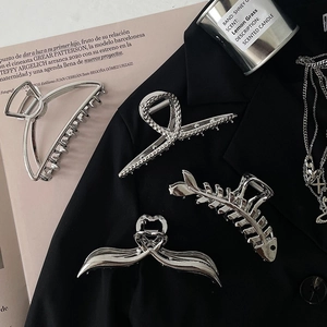 Set of four minimalist silver metal hair claws in geometric and ribbon designs