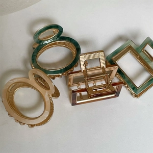 Close-up of assorted geometric acetate hair claws in various vintage summer colors