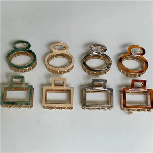 Detailed grid view of 8 acetate hair claws in marble and amber finishes with gold teeth