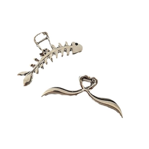 Silver metallic large shark hair clips in fishbone and streamlined wave designs