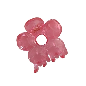 Pink translucent resin flower hair claw clip with daisy boutique engraving on white background