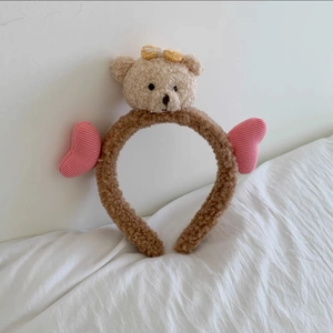 Detail showing plush brown headband with cute 3D teddy bear and pink heart charms