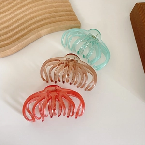 Three-piece large glossy acrylic shark hair clips in mint, amber, and coral colors