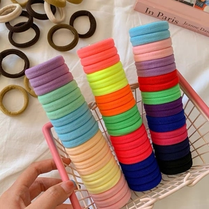 Colorful high-elastic seamless hair tie set in a pink iron basket on white fabric