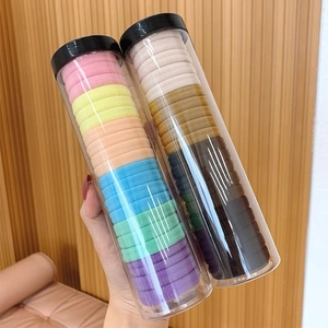 Detail of high-elastic seamless hair ties in transparent storage tubes with black lids