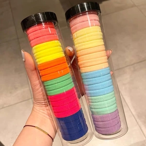 Detail of multi-colored seamless hair ties in transparent storage containers