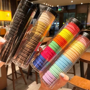 Elastic hair ties set in clear jars featuring neutral colors and high-stretch texture