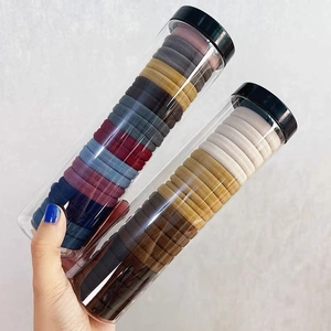 Detail view of colorful high-elastic hair ties in transparent storage containers