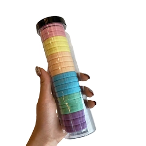 Jar of 20 durable rainbow elastic hair ties in a clear cylindrical storage container