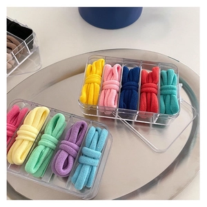Colorful elastic hair bands in a transparent five-grid storage box with candy colors