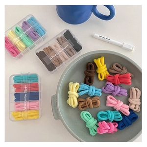 Macro detail of colorful seamless high elastic hair ties in a clear plastic storage box