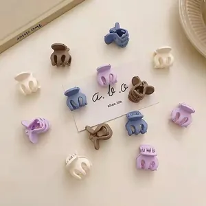 Mini matte hair claws in cream colors for fringe styling and fine hair sections