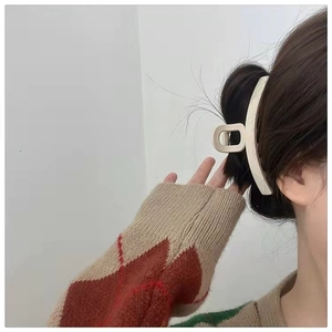 Matte cream large hair claw clip shown on brown hair for elegant updo styling