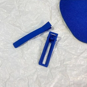 Close-up of Klein Blue matte hair clips and rectangle barrettes on white background