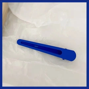 Minimalist matte Klein blue hair clip for women with streamlined design on white background