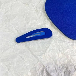 Matte Klein blue teardrop hair clip in a minimalist snap-on style for daily styling