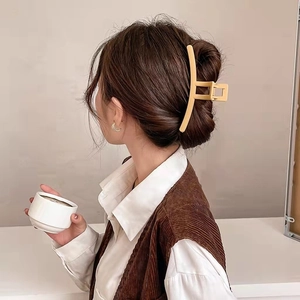 Minimalist matte cream yellow geometric hair claw clip shown on model for back-of-head styling
