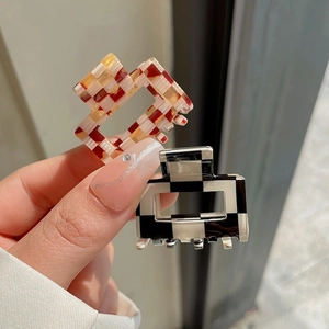 Detailed close-up of acetate square hair claws in checkerboard and colorful patterns