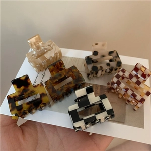 Detail view of acetate checkered and leopard pattern square hair claws in various styles